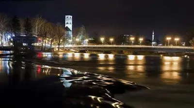 a view of a river at night with lights at Apartman Nafo in Bihać