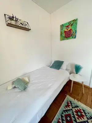 a bedroom with two twin beds and a table at Studio Bulevar in Banja Luka