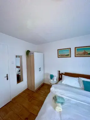 a bedroom with a bed and a door to a bathroom at Studio Bulevar in Banja Luka