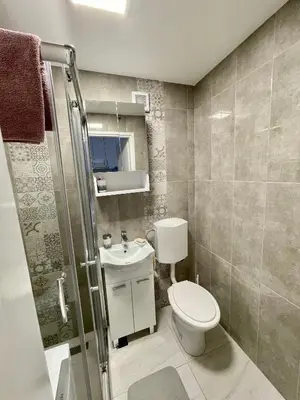 a small bathroom with a toilet and a sink at Studio Bulevar in Banja Luka