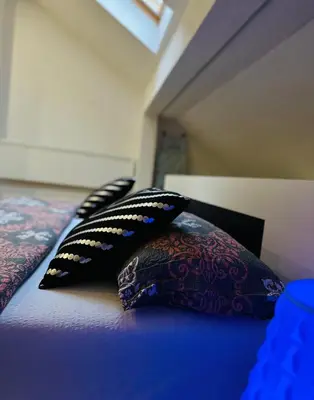 two black pillows on a bed in a room at Petra Luxury in Livno