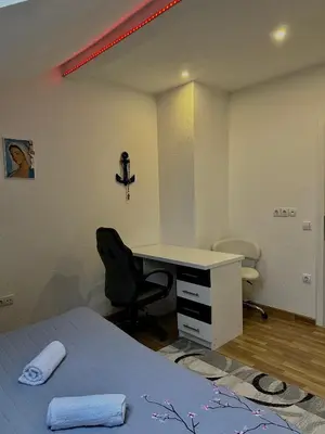 a bedroom with a desk and a bed and a desk and chair at Petra Luxury in Livno