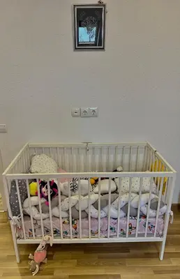 a white crib with stuffed animals in a room at Petra Luxury in Livno