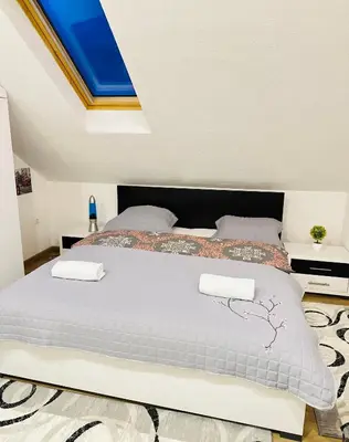 a bedroom with a large bed with two pillows at Petra Luxury in Livno