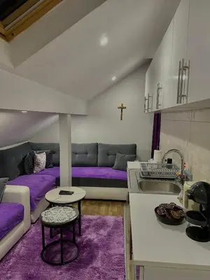 a kitchen and living room with purple beds and a sink at Petra Luxury in Livno