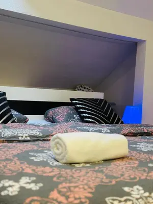 a white rolled up towel on a bed at Petra Luxury in Livno