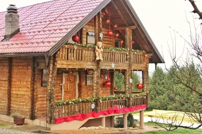 a model of a house with christmas decorations on it at Cozy Wooden Cottage in Banja Luka