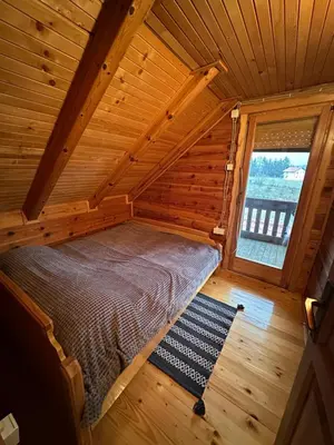 an overhead view of a bed in a wooden cabin at Cozy Wooden Cottage in Banja Luka