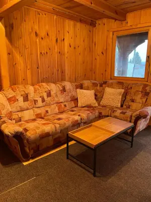 a living room with a couch and a coffee table at Cozy Wooden Cottage in Banja Luka