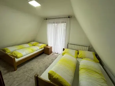 a bedroom with two beds and a window at Villa Gabi Vlašić in Travnik