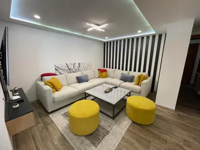 a living room with a couch and two yellow stools at Villa Gabi Vlašić in Travnik