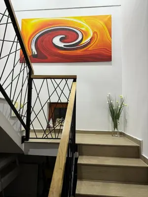 a painting on a wall next to a staircase at Villa Gabi Vlašić in Travnik