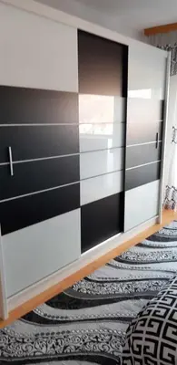 a dresser with a black and white striped wall at Ferienwohnung Sabina in Bosanska Krupa