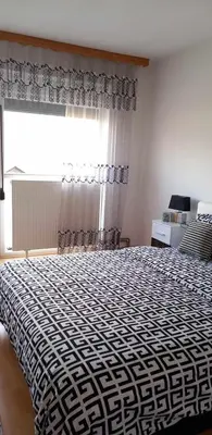 a bedroom with a black and white bed with a window at Ferienwohnung Sabina in Bosanska Krupa
