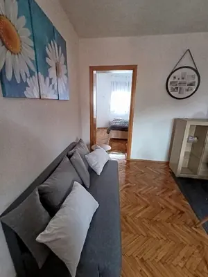 a living room with a couch with pillows on it at Stan na dan Relax in Bosanska Dubica