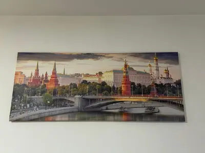 a painting of a city with a bridge and buildings at Apartman Moskva in Teslić