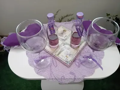 three wine glasses sitting on a table with purple items at Apartman MED in Doboj
