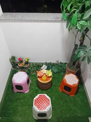 a miniature garden with three dogs and a plant at Apartman MED in Doboj