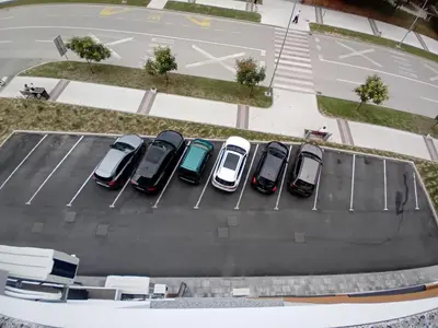 an overhead view of cars parked in a parking lot at Apartman MED in Doboj