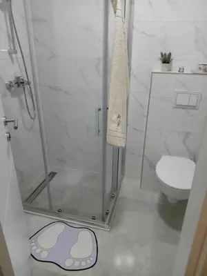 a bathroom with a shower and a toilet at Apartman MED in Doboj