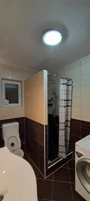 a bathroom with a toilet and a shower and a sink at Villa Aida in Bihać