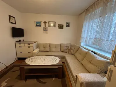 a living room with a couch and a table at Apartman Kuna in Kupres