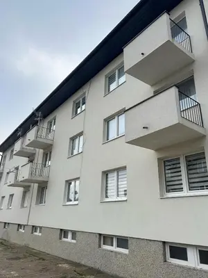 a building with balconies on the side of it at Apartman Kuna in Kupres