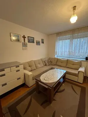 a living room with a couch and a coffee table at Apartman Kuna in Kupres