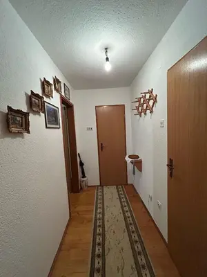 a room with a hallway with a door and a rug at Apartman Kuna in Kupres