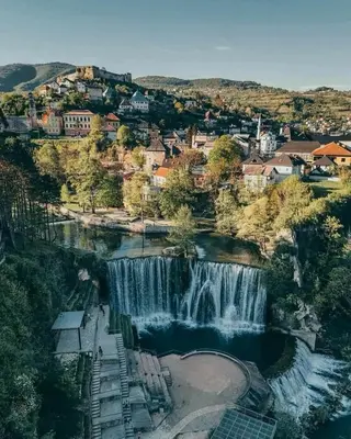 an aerial view of a waterfall in a city at Nurr in Jajce