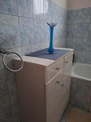 a blue vase sitting on top of a cabinet in a bathroom at Nurr in Jajce