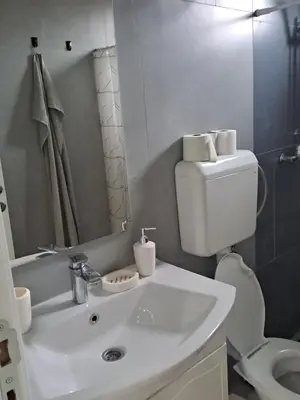 a bathroom with a white sink and a toilet at Nurr in Jajce