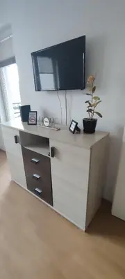 a white dresser with a tv on top of it at Apartman Rubin20 in Doboj