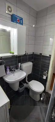 a bathroom with a toilet and a sink at Apartman Rubin20 in Doboj