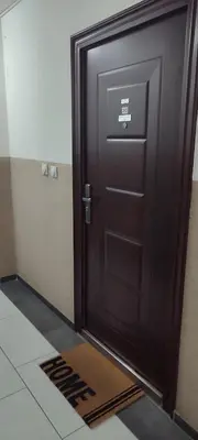 a black door in a room with a tile floor at Apartman Rubin20 in Doboj