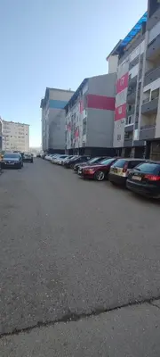 a row of cars parked in a parking lot at Apartman Rubin20 in Doboj