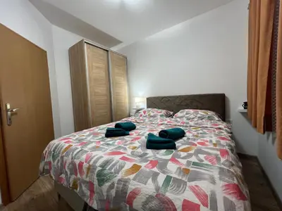 a bedroom with a bed with blue towels on it at Apartman Mrša in Livno