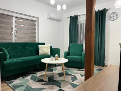 a living room with a green couch and a table at Apartman Mrša in Livno