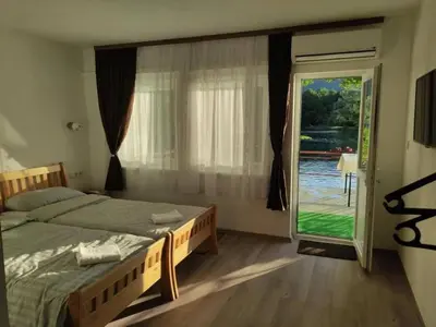 a bedroom with two beds and a sliding glass door at Luxury Villa Tale - Una in Ripač