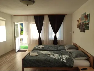a bedroom with a bed and a large window at Luxury Villa Tale - Una in Ripač