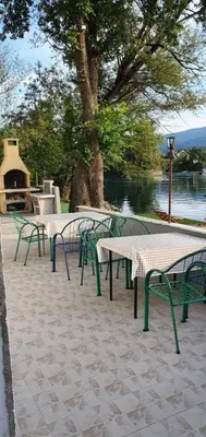 a group of tables and chairs next to the water at Luxury Villa Tale - Una in Ripač