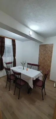 a dining room with a white table and chairs at Luxury Villa Tale - Una in Ripač