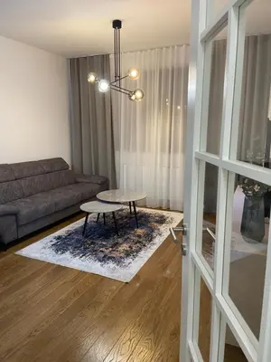 a living room with a couch and a table at Metropolis Apartman in Banja Luka