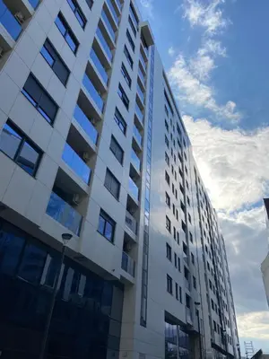 a tall building with many windows on the side of it at Metropolis Apartman in Banja Luka