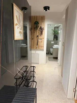 a room with a glass table and chairs and a bathroom at River Oasis in Banja Luka