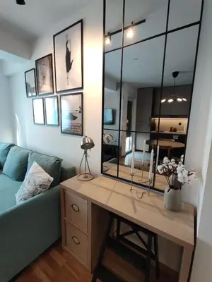 a living room with a blue couch and a mirror at River Oasis in Banja Luka