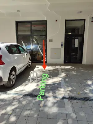 a white car parked in front of a building at River Oasis in Banja Luka