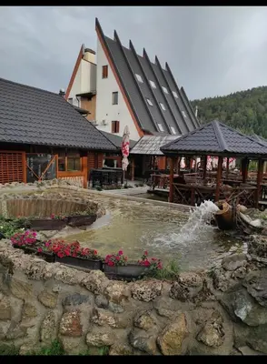 a building with a fountain in front of a building at Stan na dan Miki -M Teslic in Teslić