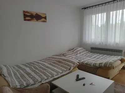 a room with a bed and a table and a window at Stan na dan Miki -M Teslic in Teslić