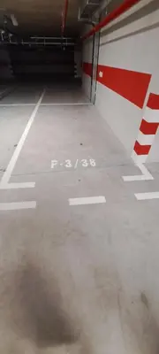 an empty parking garage with the words poo on the floor at Apartman LUAN5 centar in Banja Luka